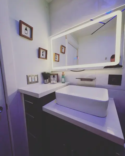Modern vanity with vessel sink and lit mirror