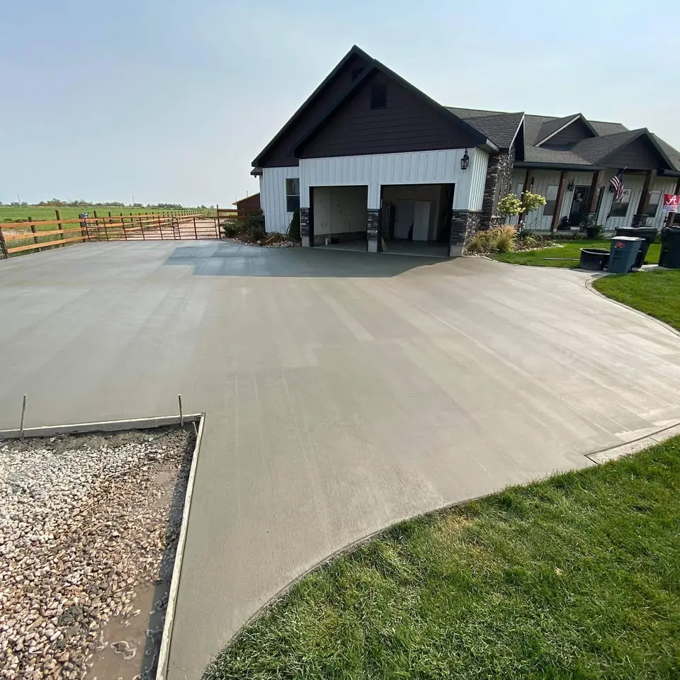 Freshly poured concrete driveway in front of a new home