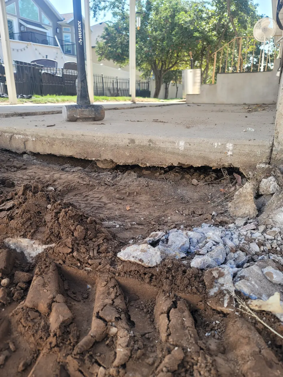 Failed concrete slab from another contractor, undermined because no structural fill was used