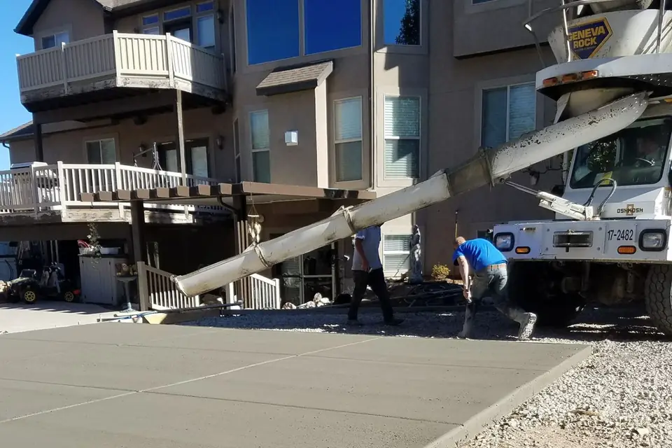 Concrete pump truck placing concrete at a multi-unit residential building